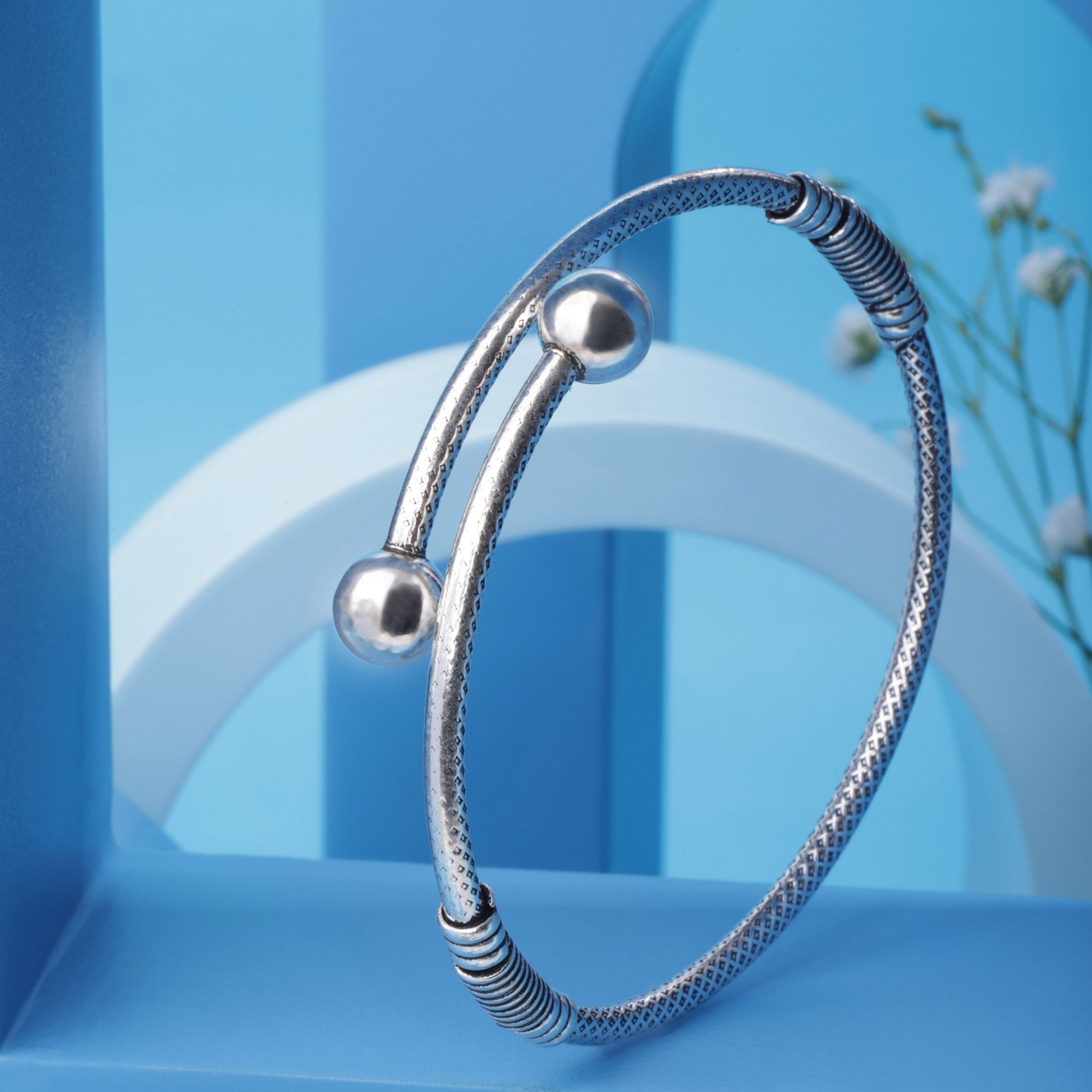 Elegant oxidised silver bangle with intricate floral design by SILVISH, named 'Floral Finesse Versa Wrist'