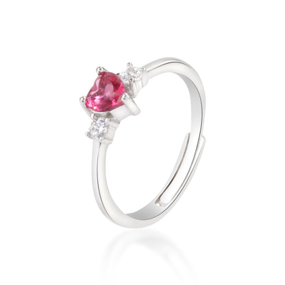 Red heart shaped silver ring on white background