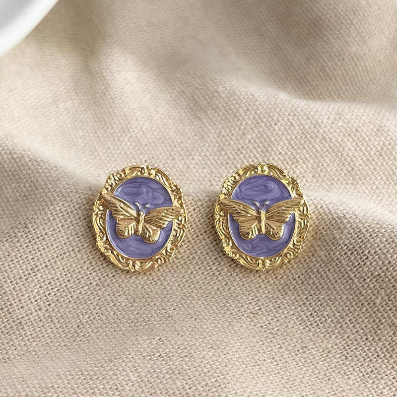 Gold butterfly oval stud earrings
